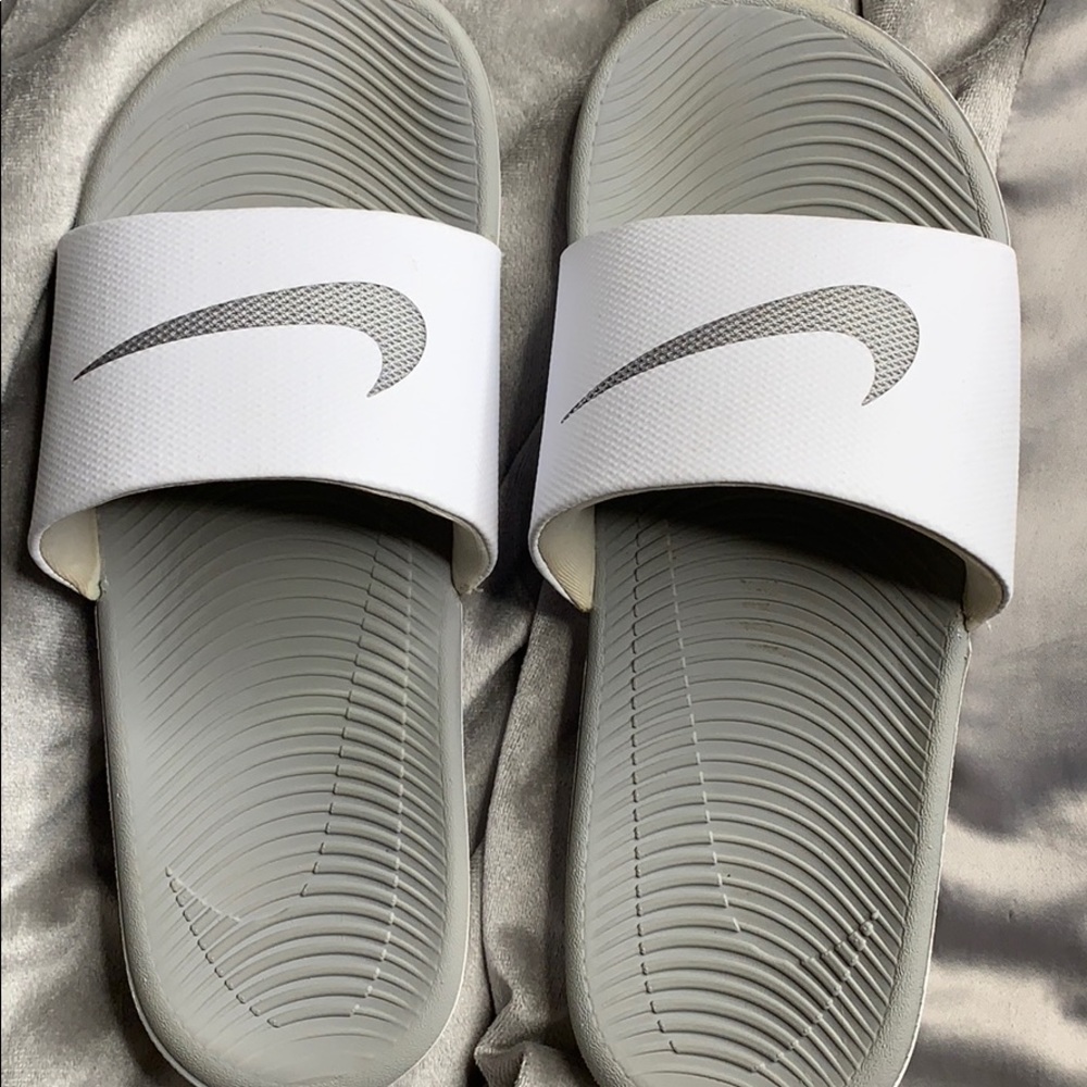 Grey and white nike slides